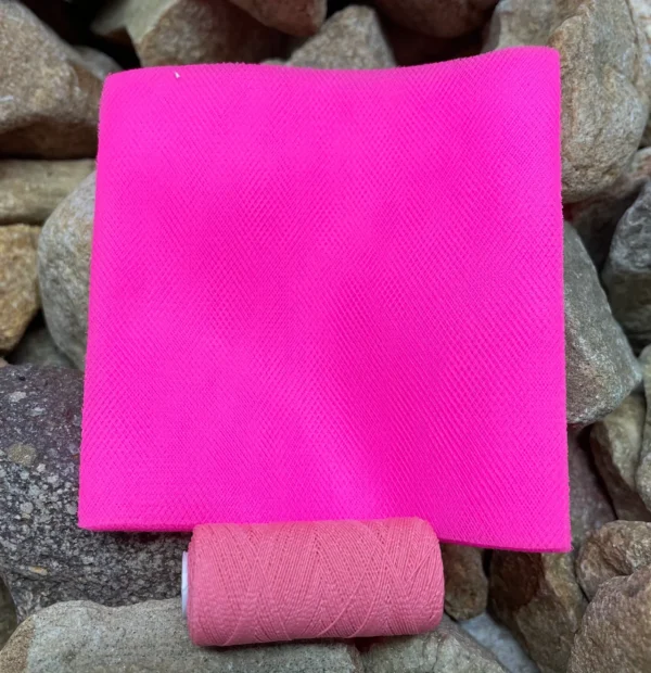 A pink paper with a roll of toilet paper on top