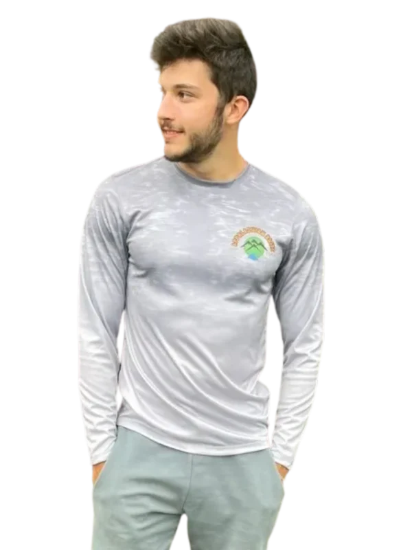 A man wearing a long sleeve shirt with a rainbow on it.