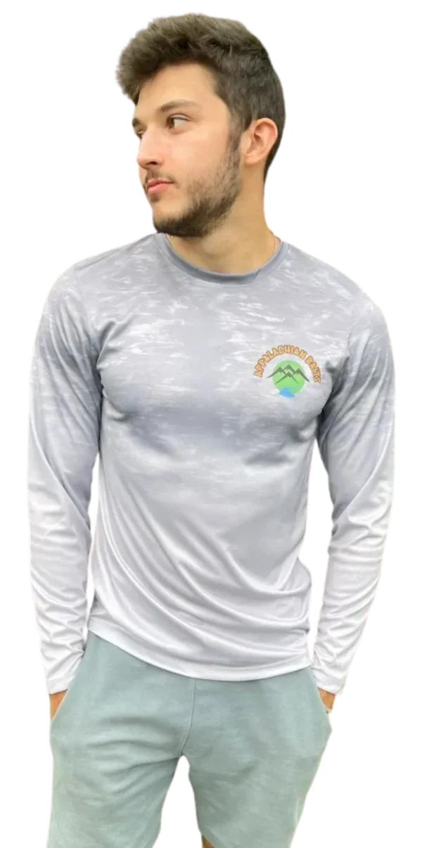 A man wearing a long sleeve shirt with a logo on it.