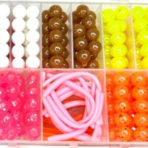 A box of beads and cords in various colors.