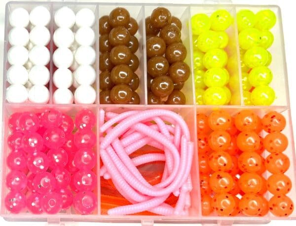 A box of beads and cords in various colors.