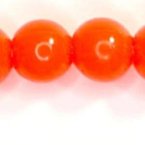 A row of orange beads sitting on top of each other.