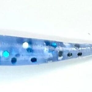 A blue and black speckled spoon on top of a table.