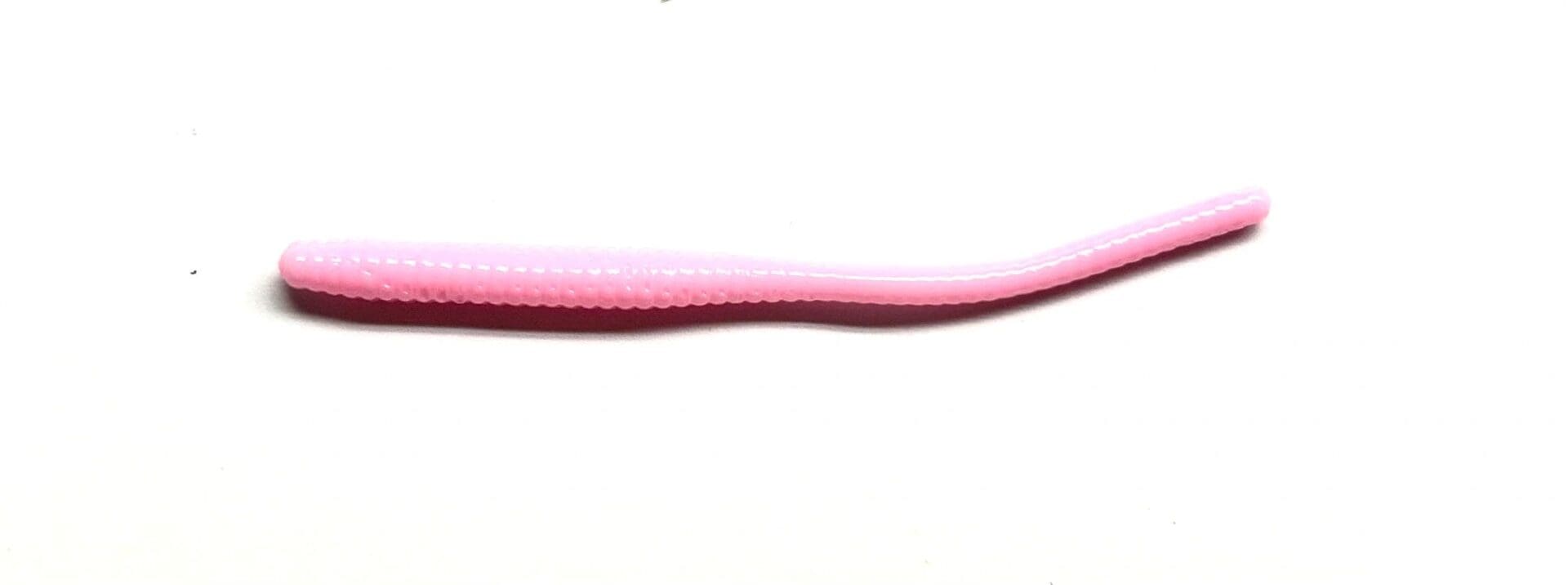 A pink plastic tube with a long handle.