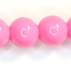 A row of pink beads sitting on top of each other.