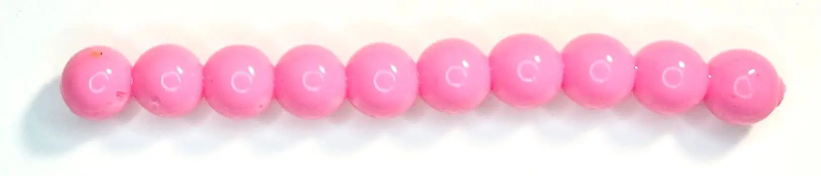 A row of pink beads sitting on top of each other.