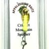 A yellow fishing lure hanging on the side of a card.