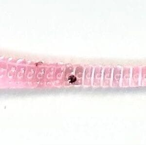 A pink bracelet with a ladybug on it.