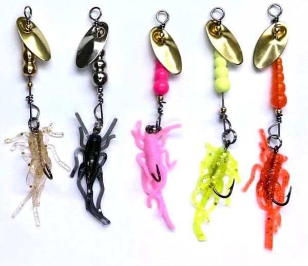 A group of different colored fishing lures hanging on a line.