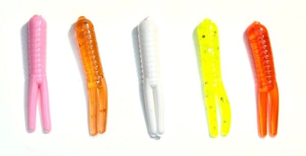 A group of three different colored plastic fishing lures.