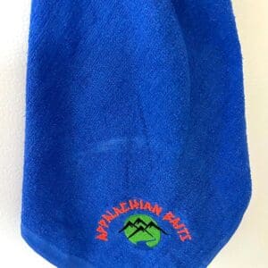 A blue towel with an embroidered logo.