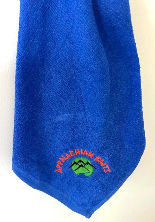 A blue towel with an embroidered logo.