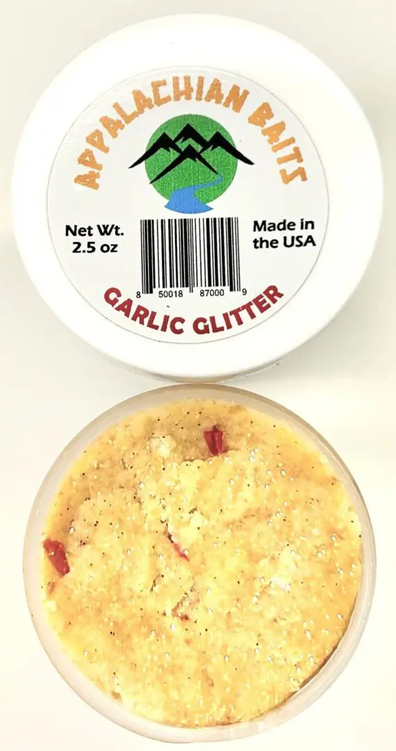 A container of garlic glitter next to another container.