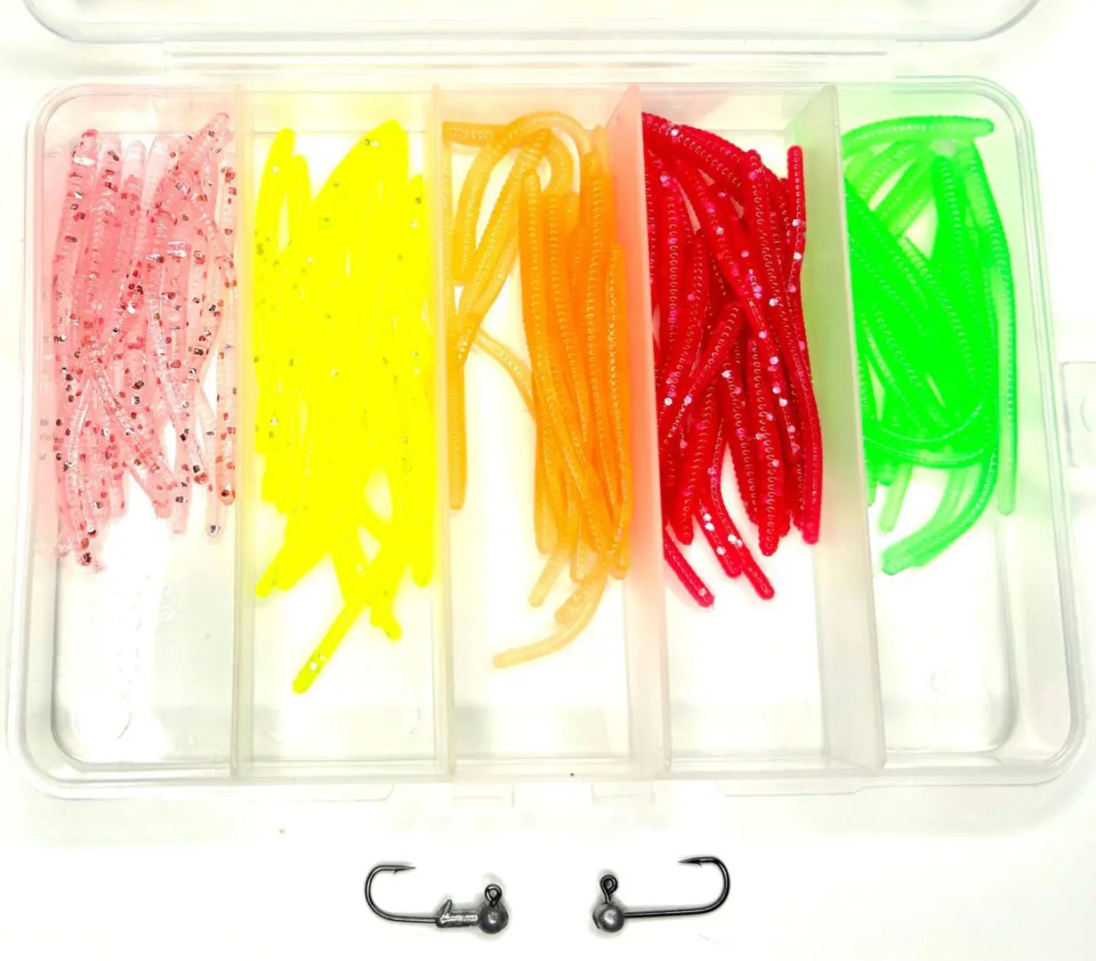 A plastic container filled with different colors of fishing baits.