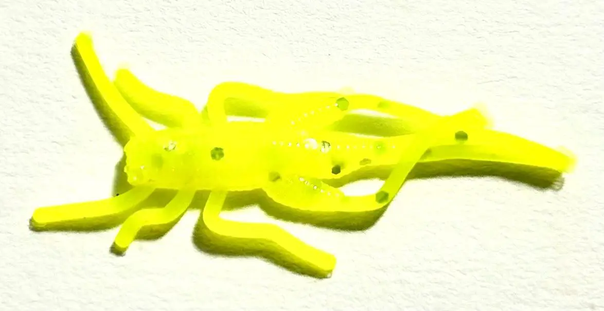 A yellow plastic snake with holes in it.