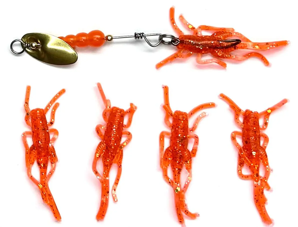 A group of plastic orange shrimp with a fishing hook.