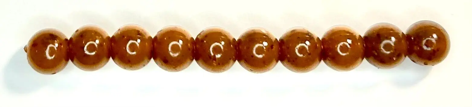 A string of brown beads with white writing on it.