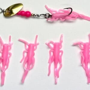 A pink fishing lure with several different types of plastic.