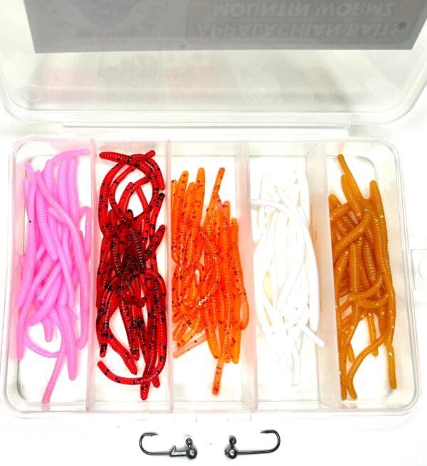 A box of different colored plastic fishing hooks.