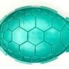 A green turtle shell shaped bowl sitting on top of a table.