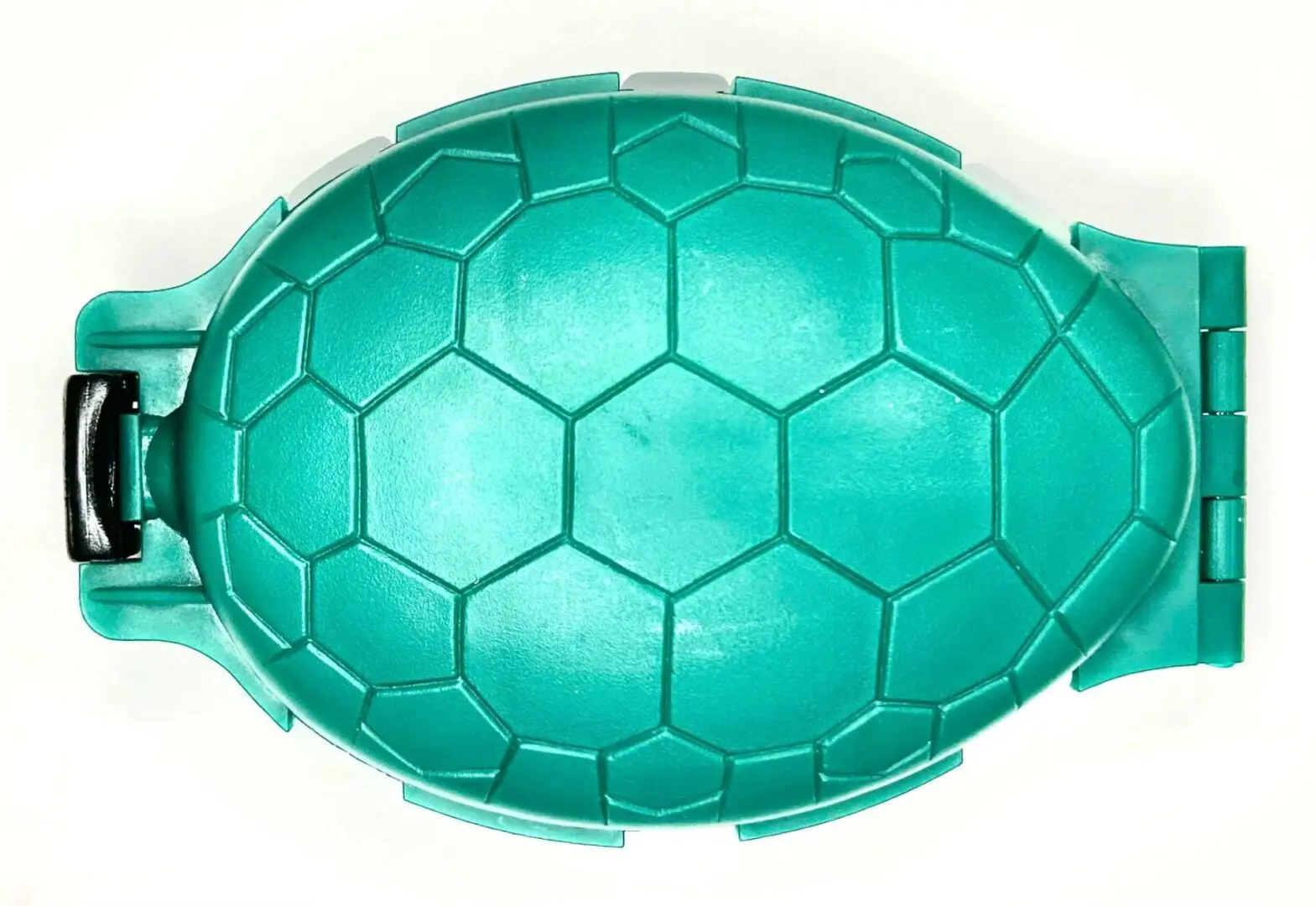 A green turtle shell shaped bowl sitting on top of a table.