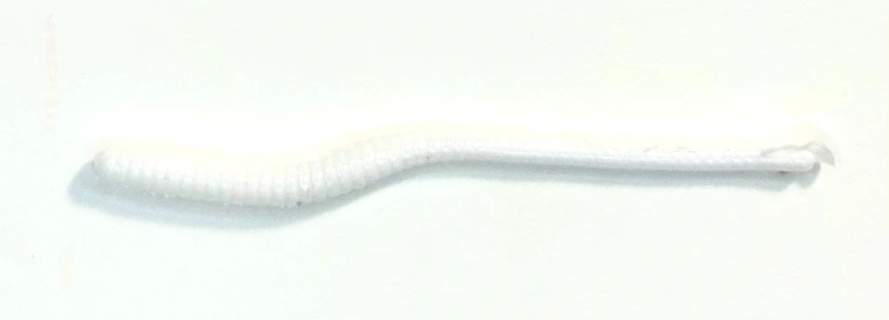 A white toothbrush with a long handle and no bristles.