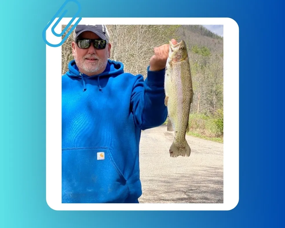 A man holding a fish in his hand.