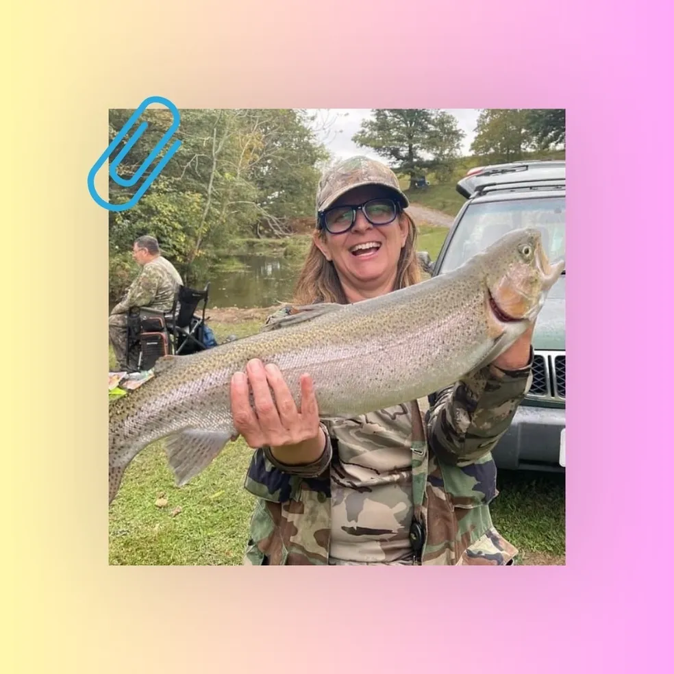 A woman holding a fish in her hands.