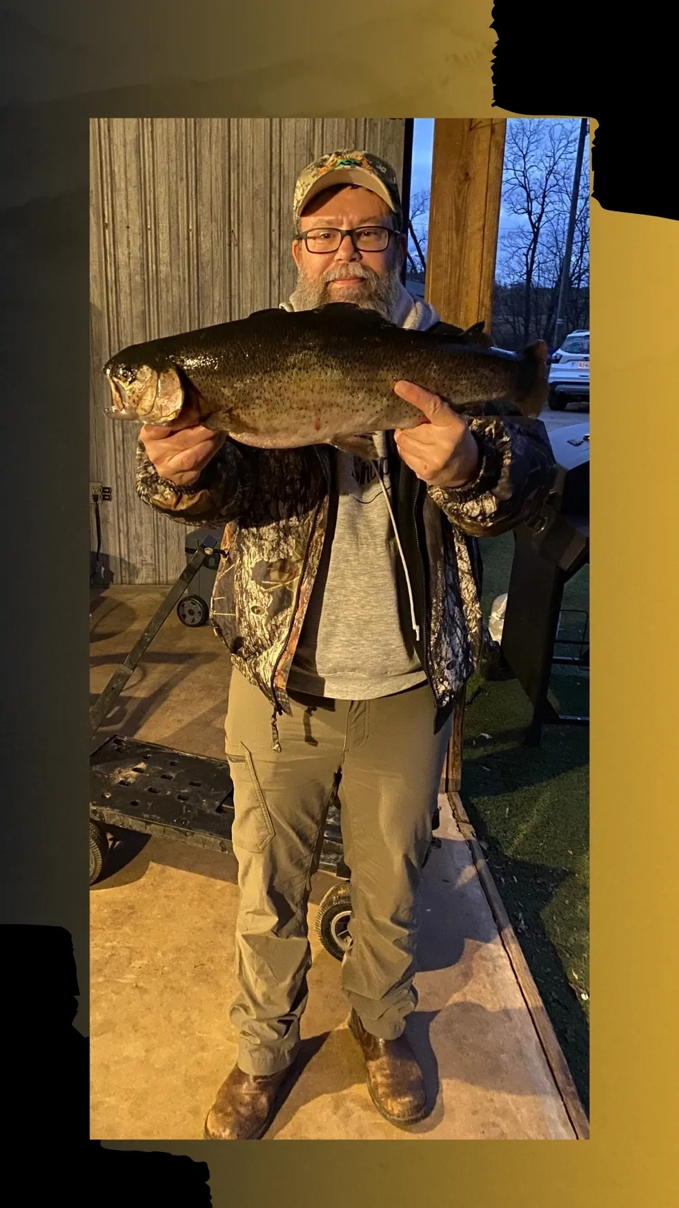 A man holding a large fish in front of him.